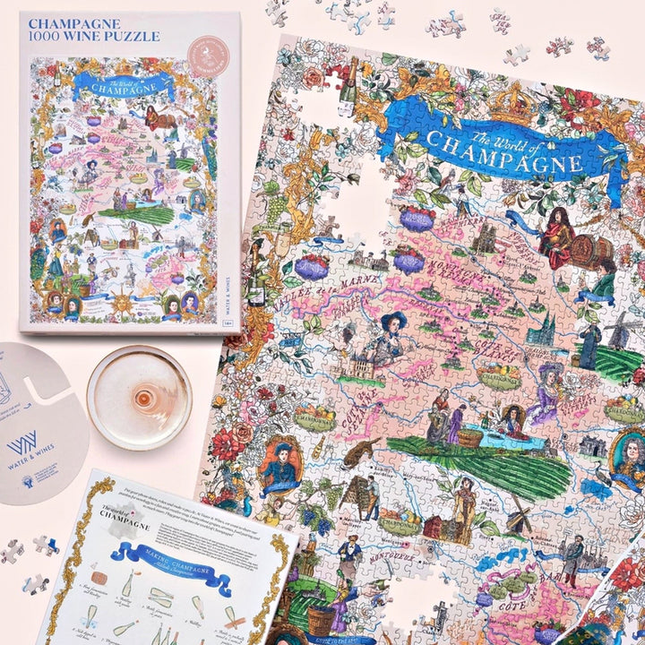 Arrangement aus Puzzle-Box, dem ausgebreiteten Puzzlemotiv, einem Informationsblatt (Making Champagne) und einem Weinglas-Ausschnitt.